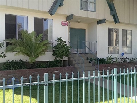 a house with a white fence in front of it