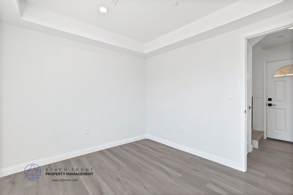 the interior of a white room with white walls and wood floors