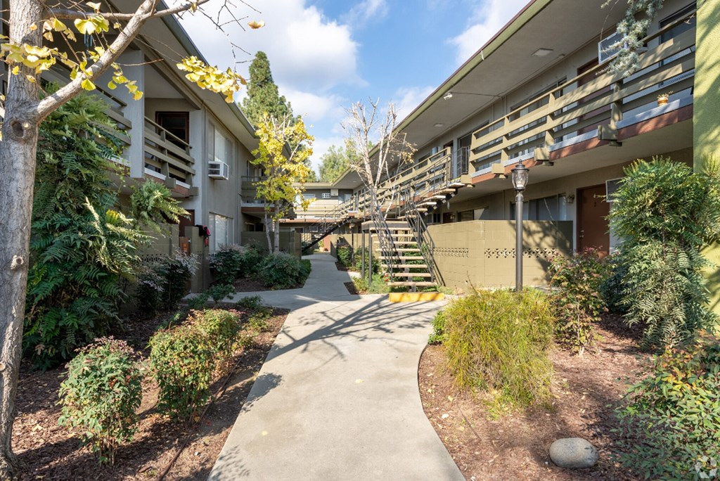 a walkway leading up to a building with stairs