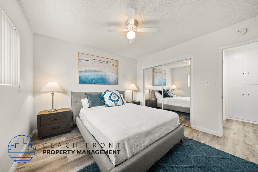 a bedroom with a bed and a ceiling fan