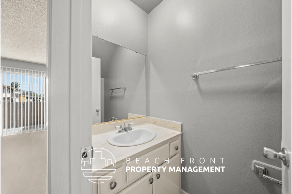 a bathroom with a sink and a mirror and a shower