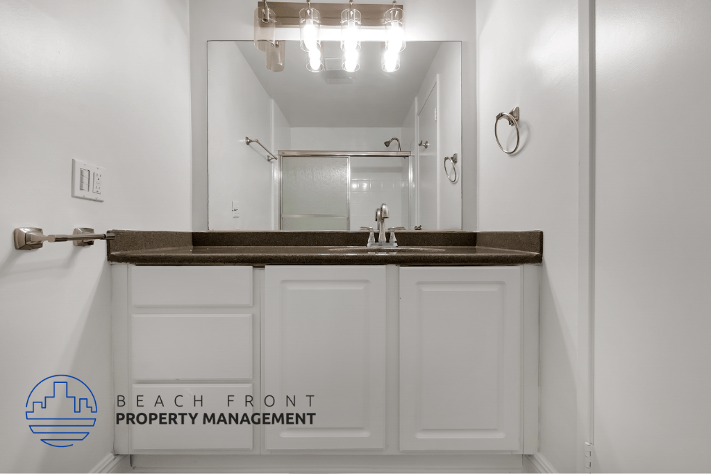 a bathroom with white cabinets and a sink and a mirror