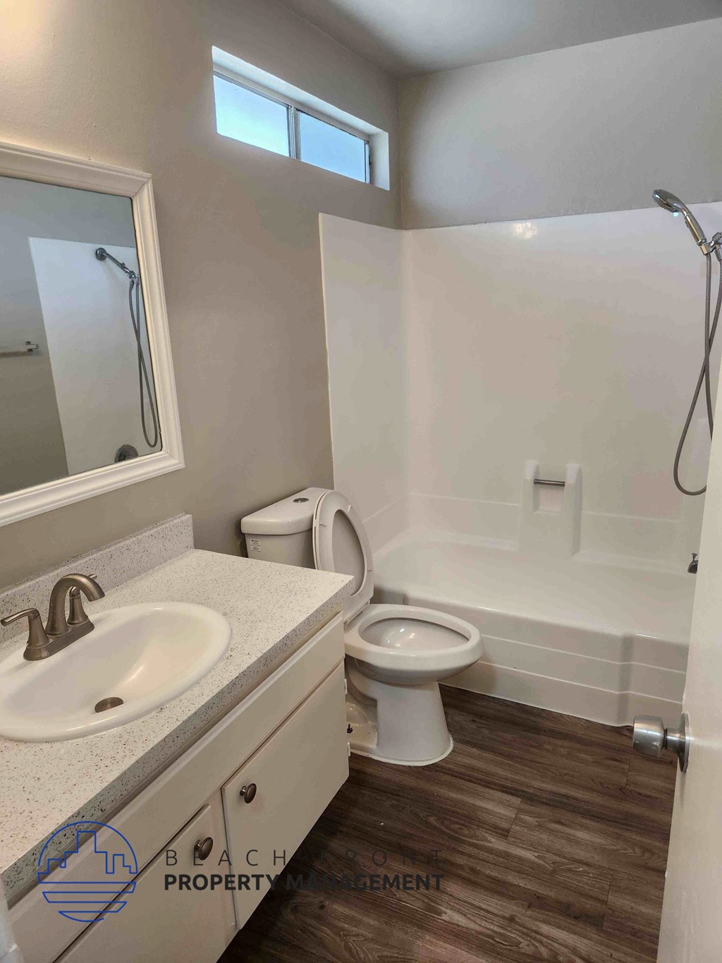 A bathroom with a sink, toilet, and bathtub.