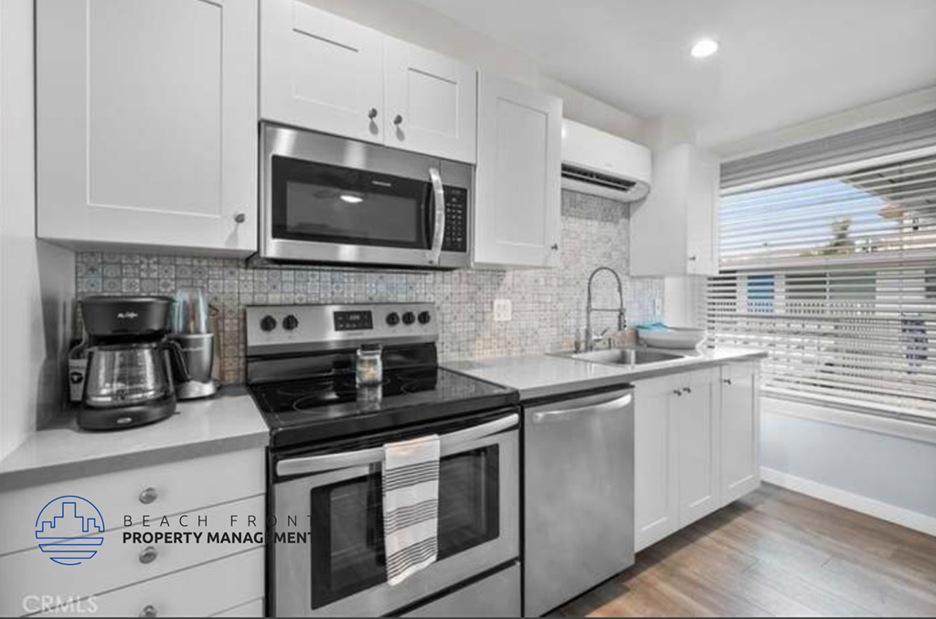 a kitchen with stainless steel appliances and white cabinets