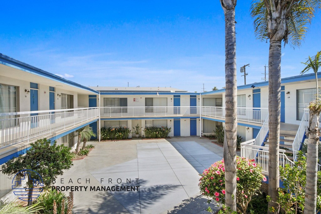 A beachfront property management building with blue and white exterior.