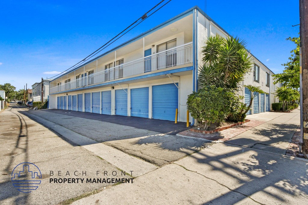 A building with a blue door is managed by Beach Front Property Management.