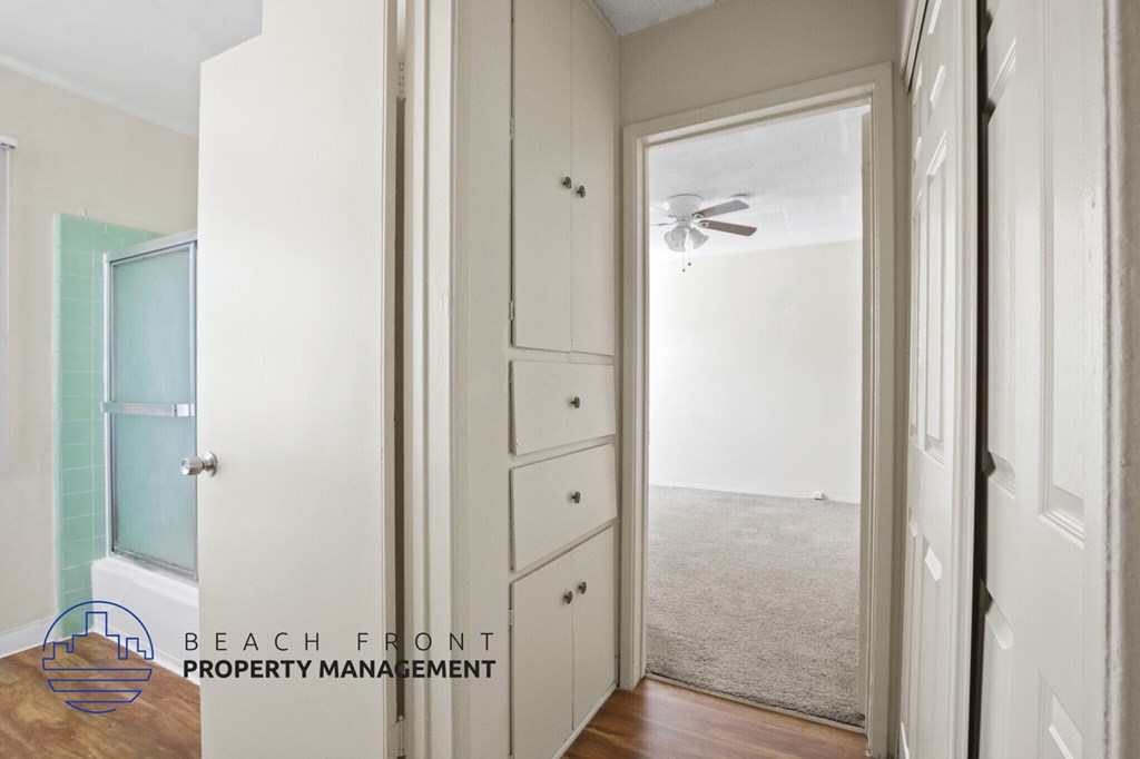 A room with a doorway leading to a hallway.