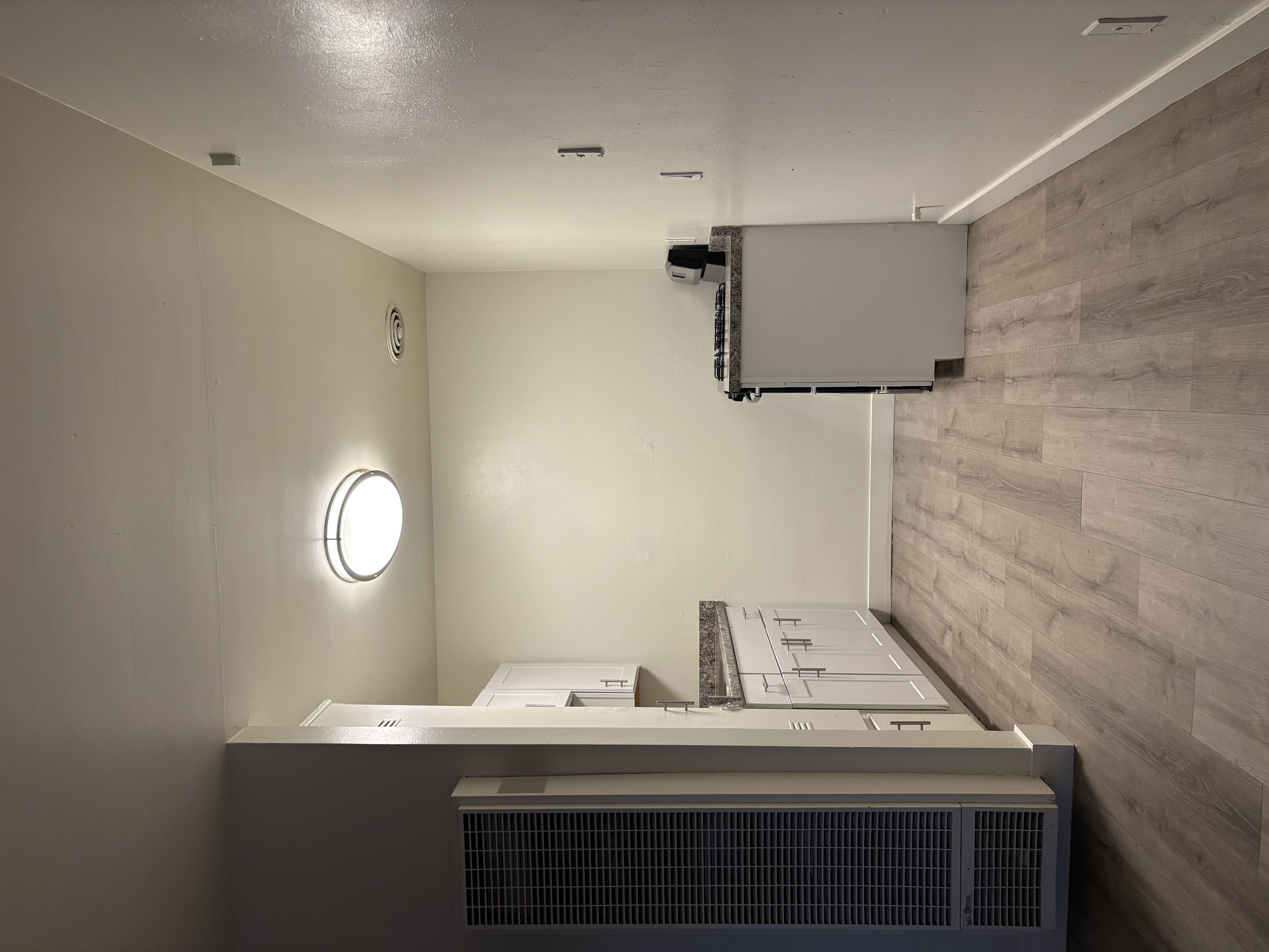 A wall-mounted air conditioning unit is installed on a wall.