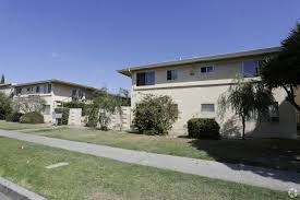 two apartment buildings on the side of a sidewalk