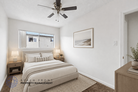 A bedroom with a bed, nightstands, and a ceiling fan.