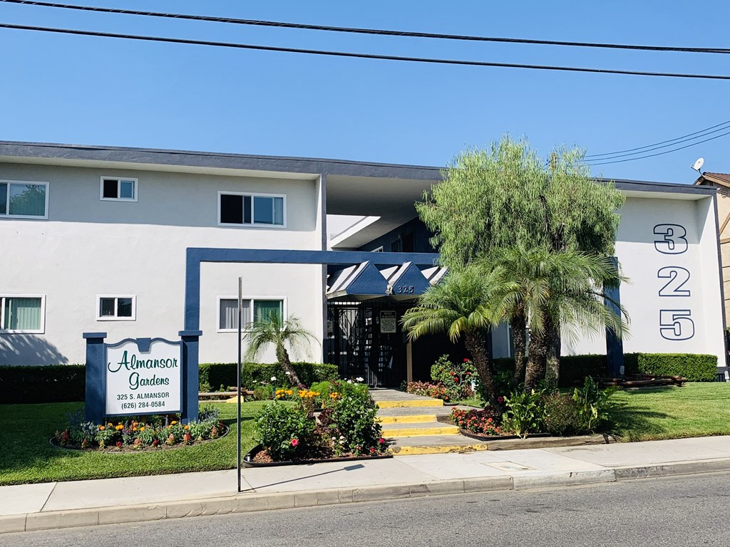 a white building with a sign in front of it
