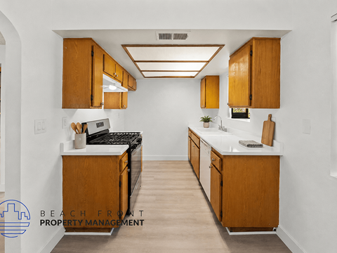 A kitchen with wooden cabinets and a white countertop.