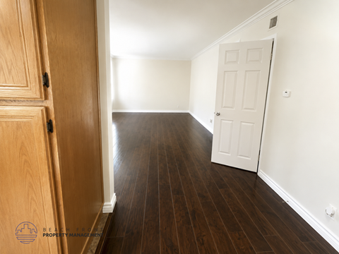 A room with wooden floors and a white door.