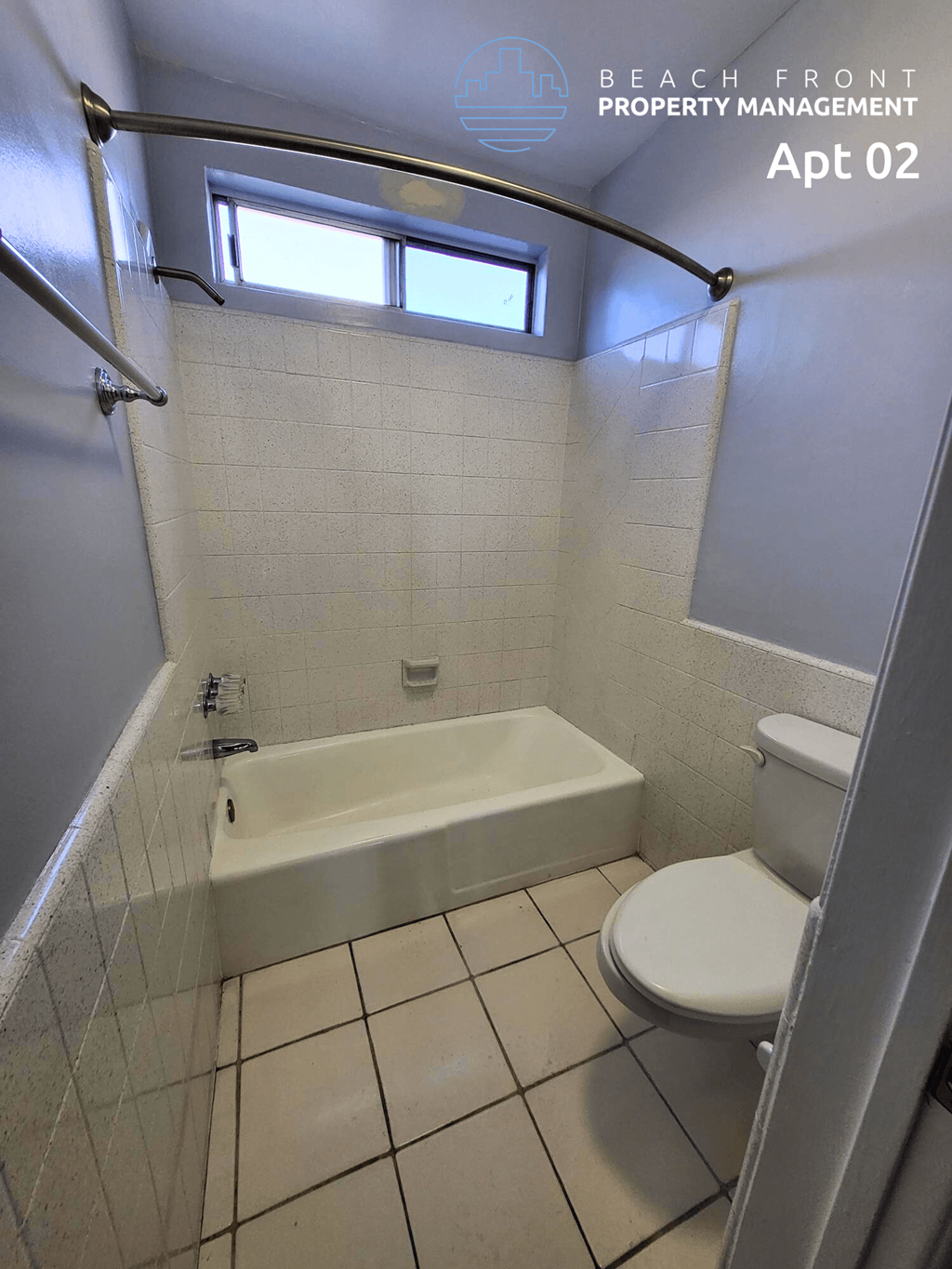 a bathroom with a toilet and a tub and a window