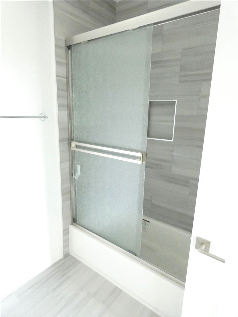 a shower with a glass door in a bathroom