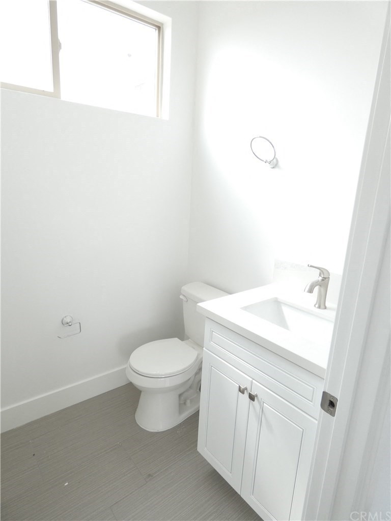 a white bathroom with a toilet and a sink