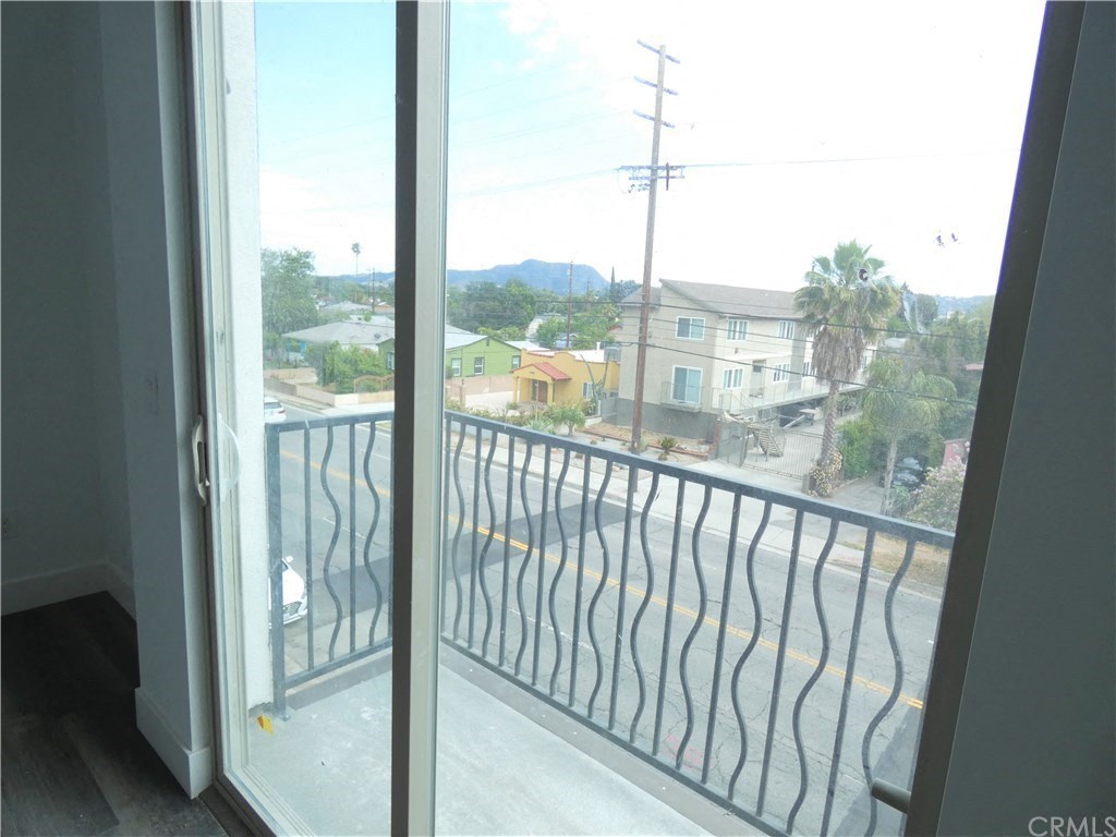 a room with a balcony and a view of the street