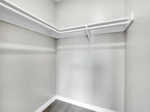 A white shelf is mounted on a white wall.