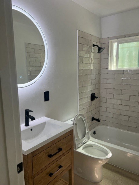 a bathroom with a toilet and a sink and a tub