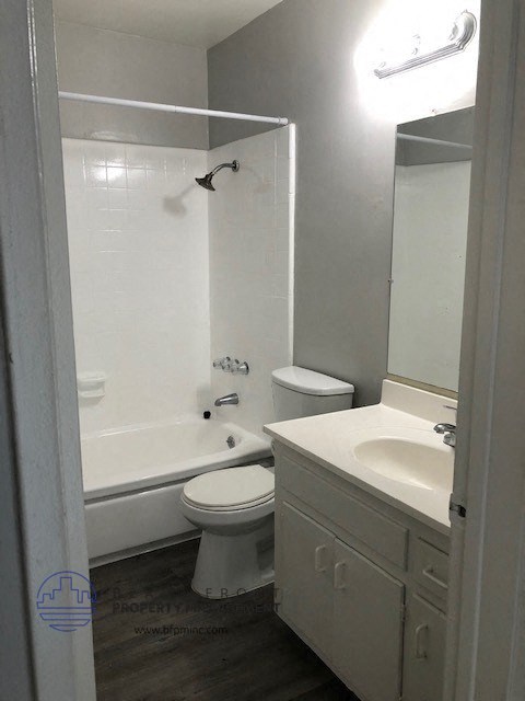a bathroom with a toilet and a tub and a sink