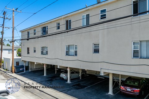 A building with a parking lot in front of it.