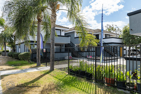 A building with a black fence and a flag on top.