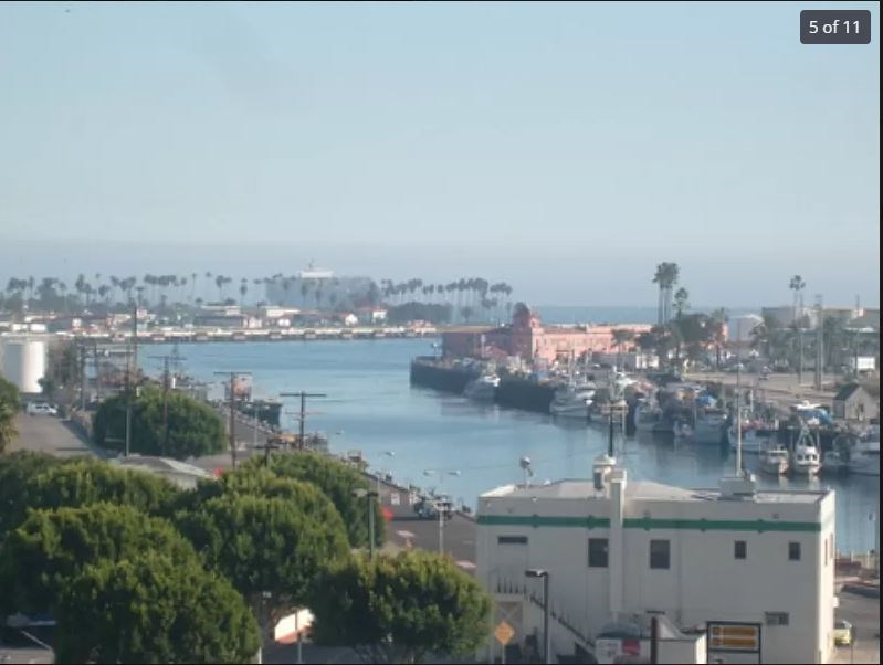 A view of a harbor with boats and buildings.