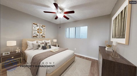 A bedroom with a bed, nightstand, and a ceiling fan.