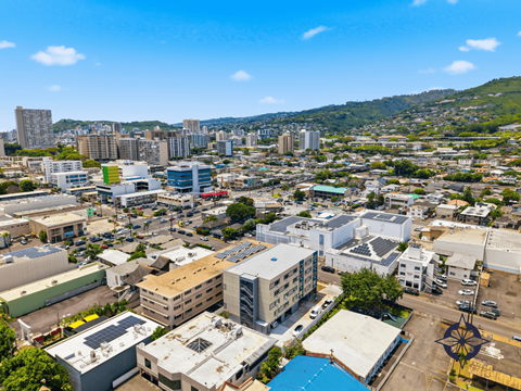 A cityscape with buildings of various sizes and a clear blue sky above.