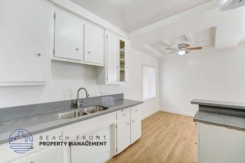 A kitchen with a sink and a fan.