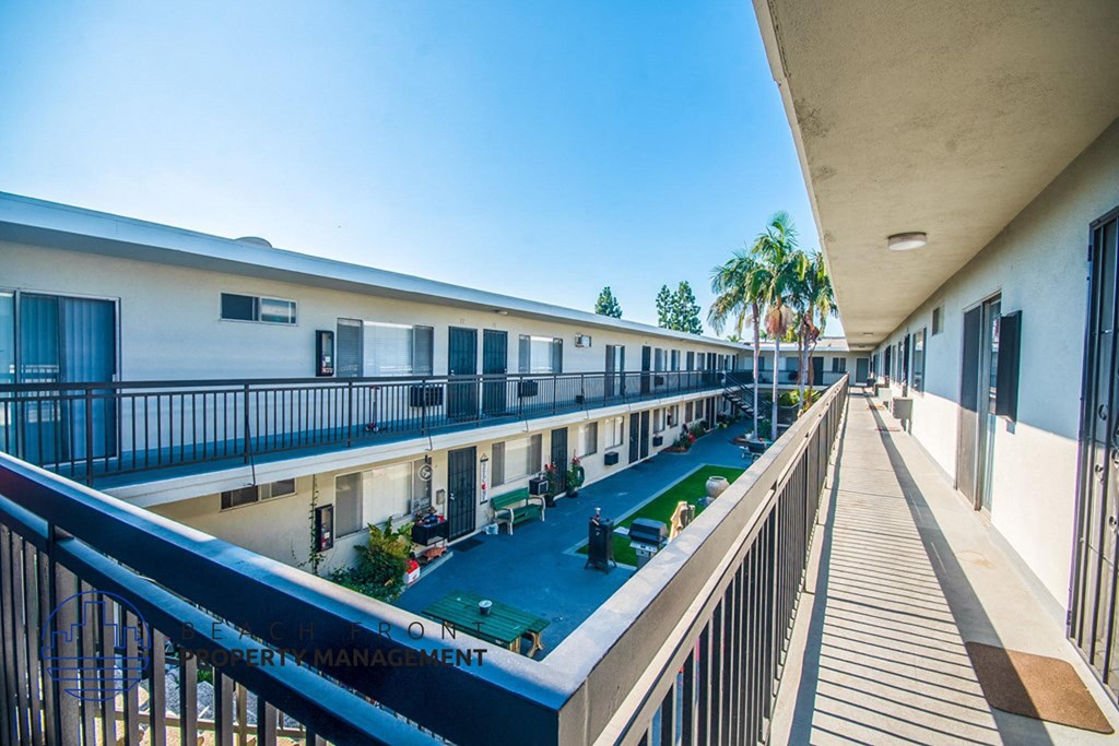 a view of a building with a pool and balconies