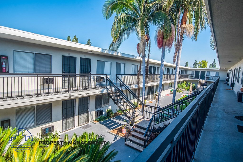 a building with stairs and palm trees