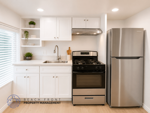 A modern kitchen with a stainless steel refrigerator and stove.