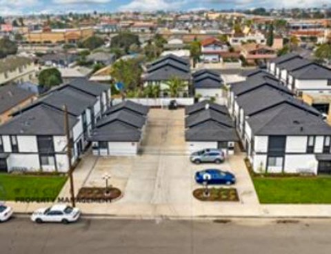 an aerial view of a neighbourhood with houses and cars parked