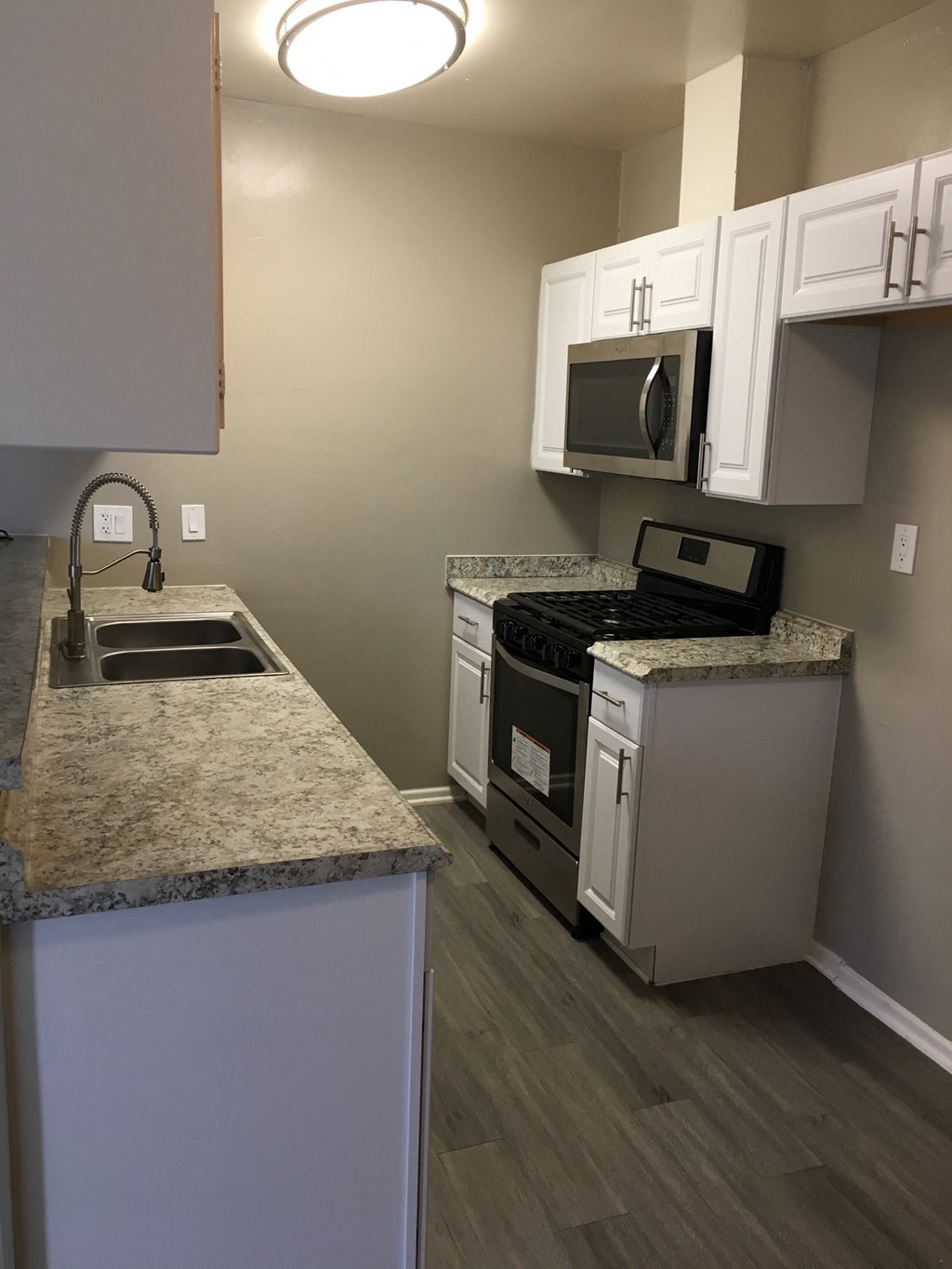 a kitchen with granite counter tops and stainless steel appliances