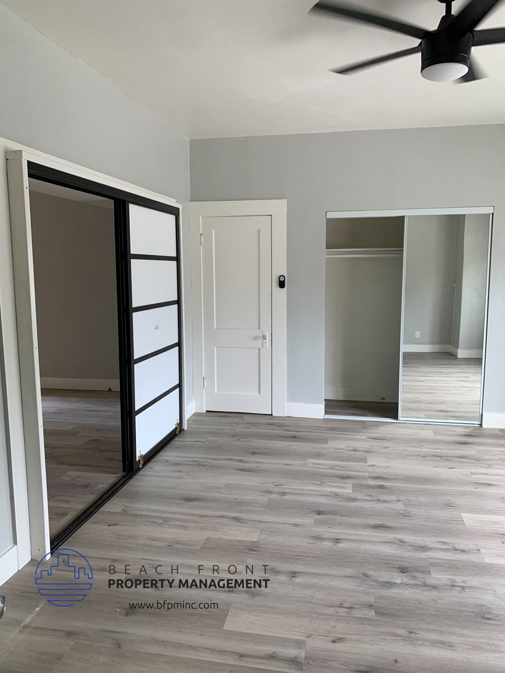a clean and empty room with a sliding glass door