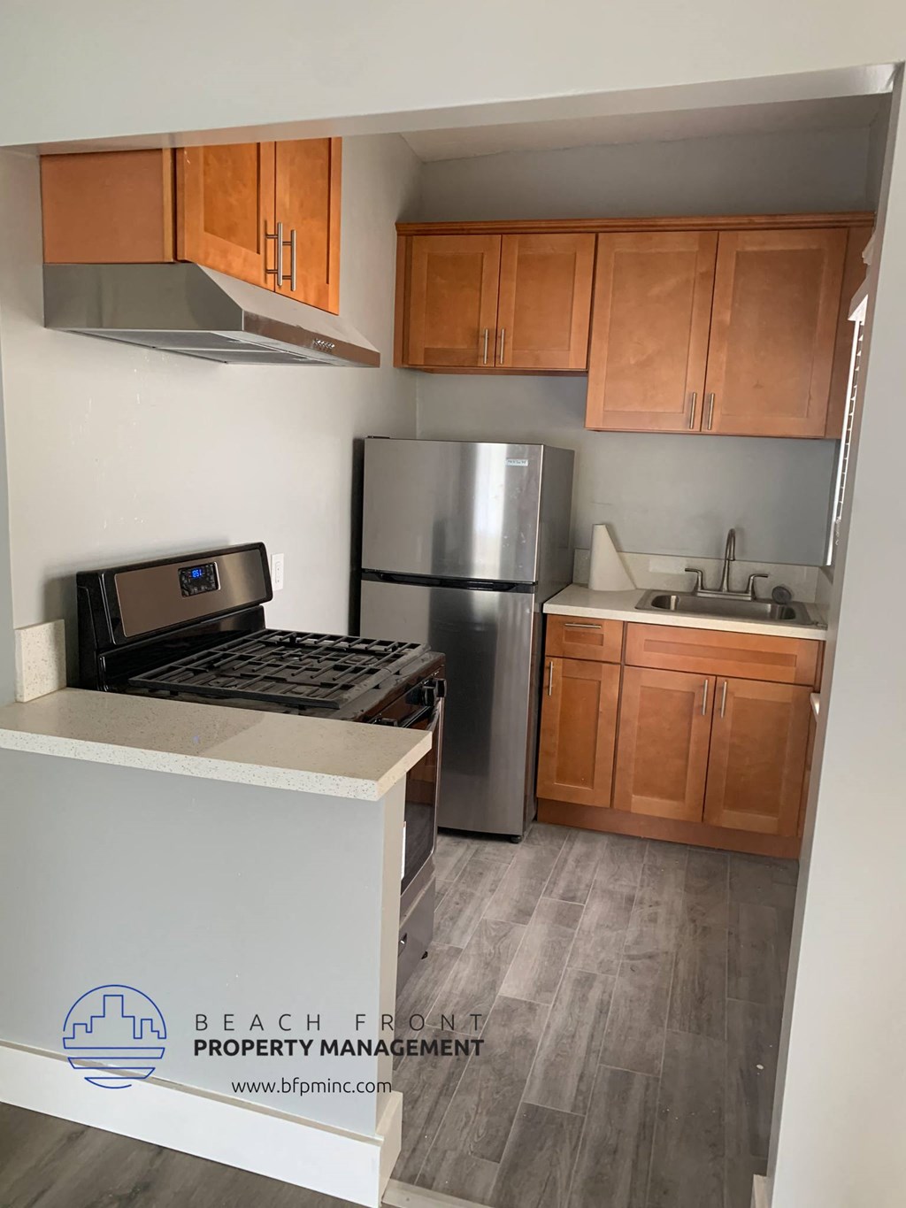 a kitchen with a stove refrigerator and cabinets