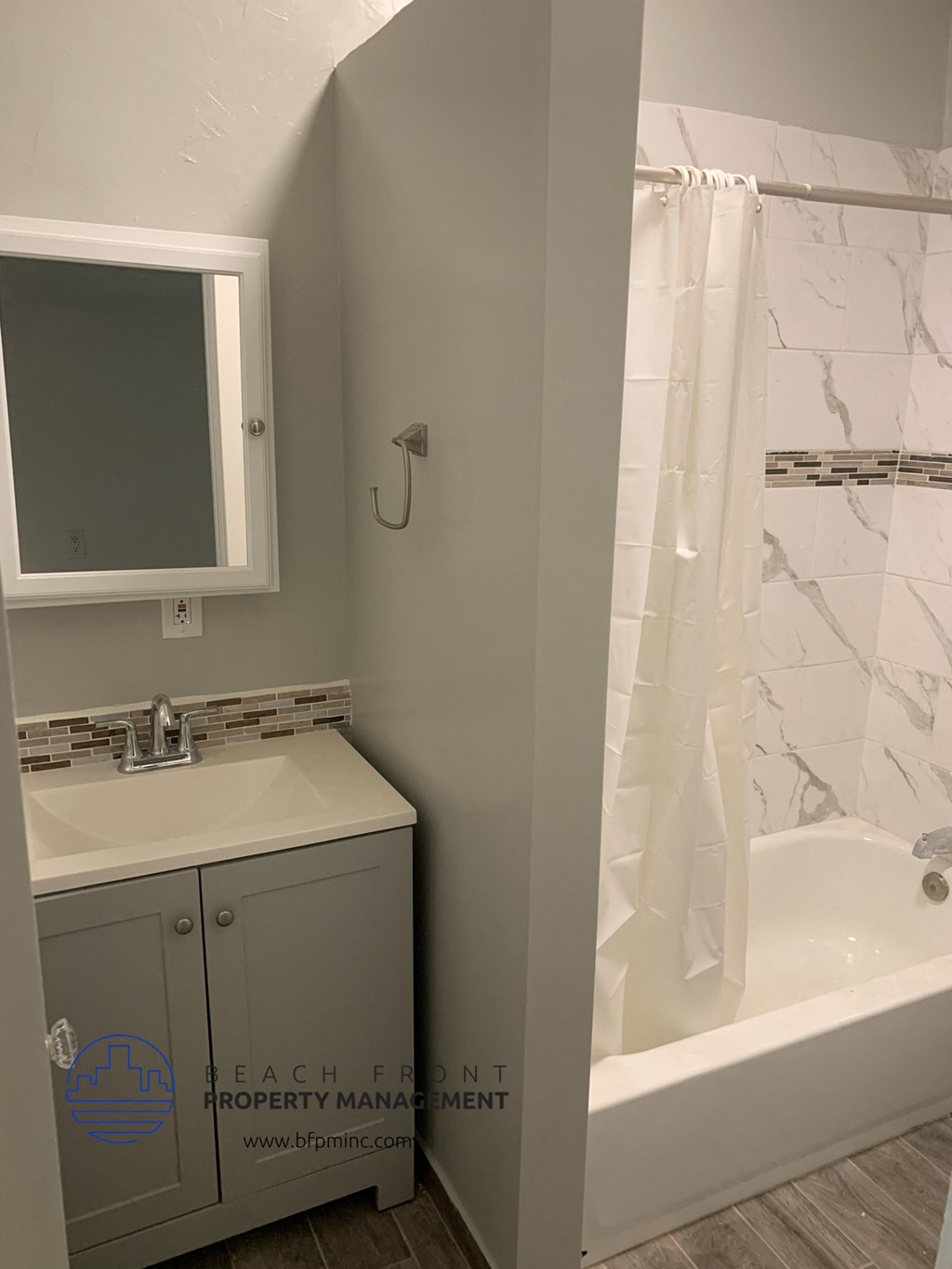 a bathroom with a sink and a tub and a mirror
