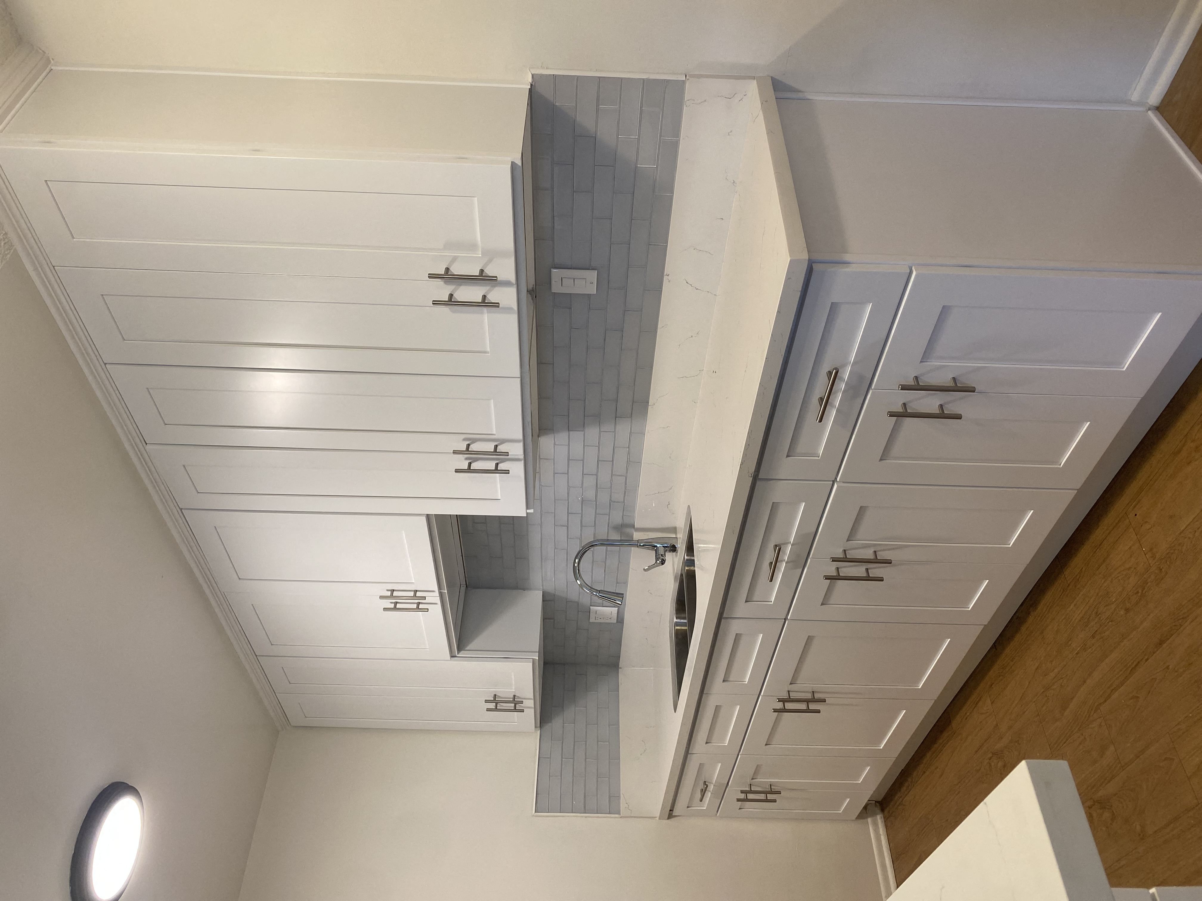 a view from the top of the stairs looking down into the bathroom