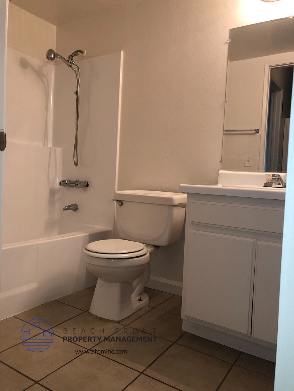 a bathroom with a toilet and a tub and a sink
