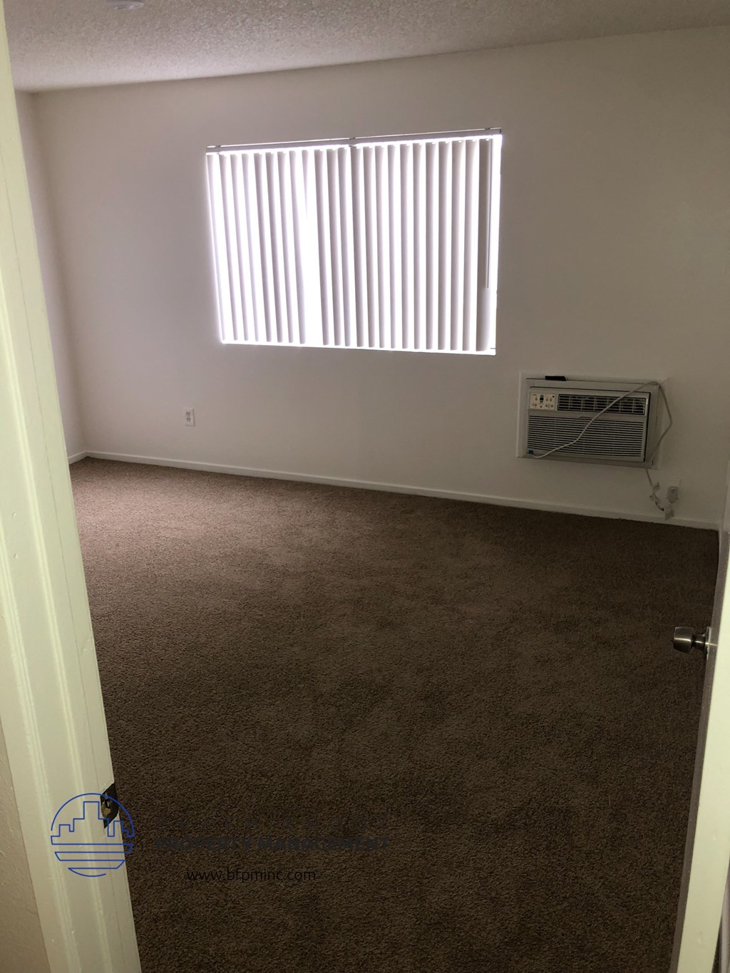 an empty room with a heater and a window
