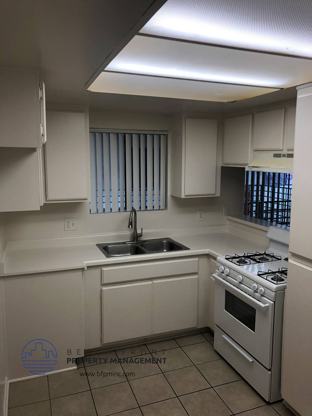 a kitchen with a sink and a stove