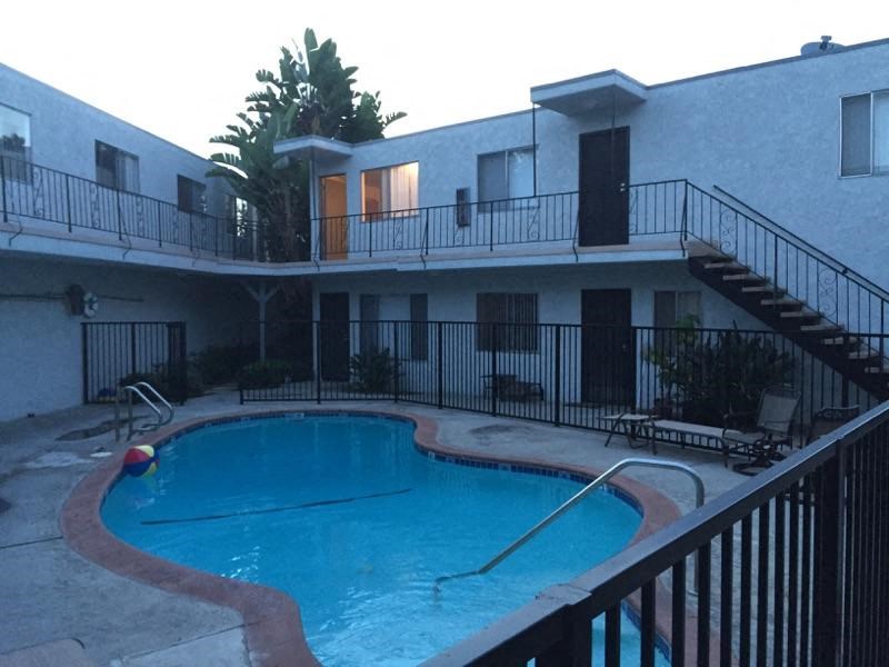 a large swimming pool in front of a building
