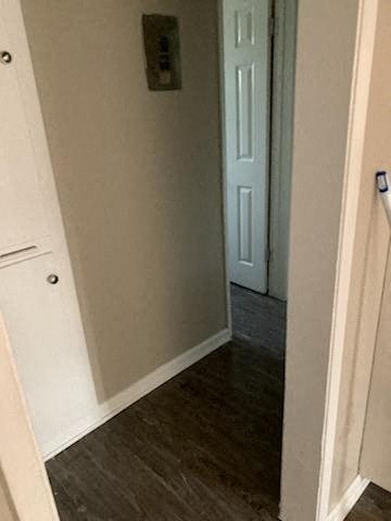 a hallway with a door and a white door