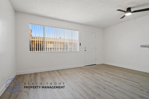 A room with a wooden floor and a ceiling fan.
