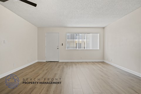 A room with a door and a window with blinds.