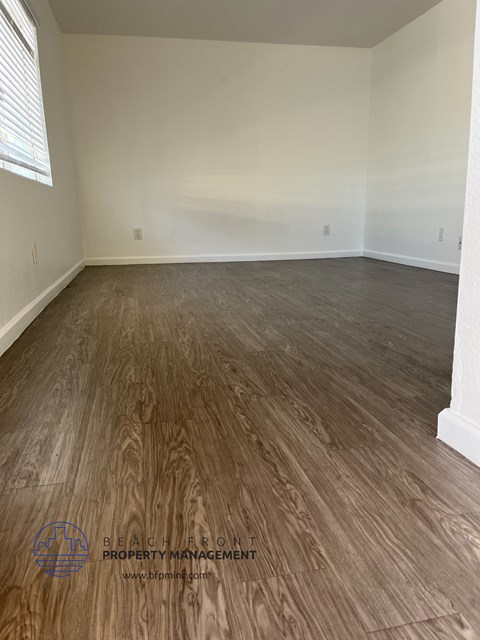 the living room of a home with wood flooring