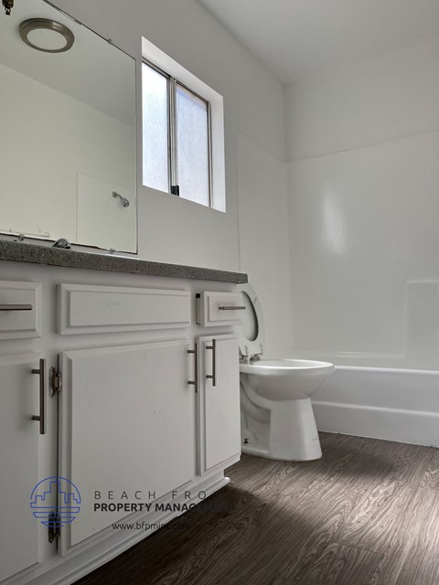 a white bathroom with a toilet and a sink