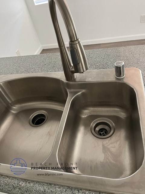 a stainless steel kitchen sink with a chrome faucet