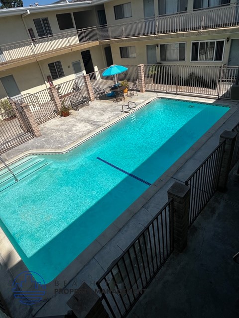 A small pool with a fence around it.